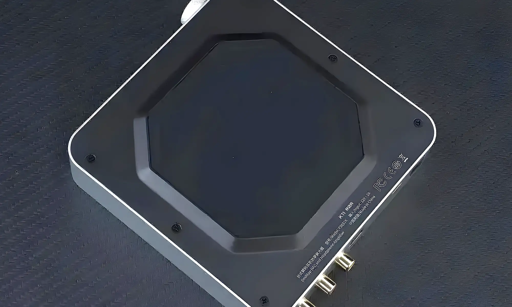 FiiO K11 R2R: нижняя панель корпуса с силиконовой противоскользящей накладкой, крупный план на темном столе.
